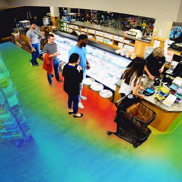 Overhead security camera view of a grocery store service counter with a colorful heat-map overlay on the floor showing where shoppers walk and linger