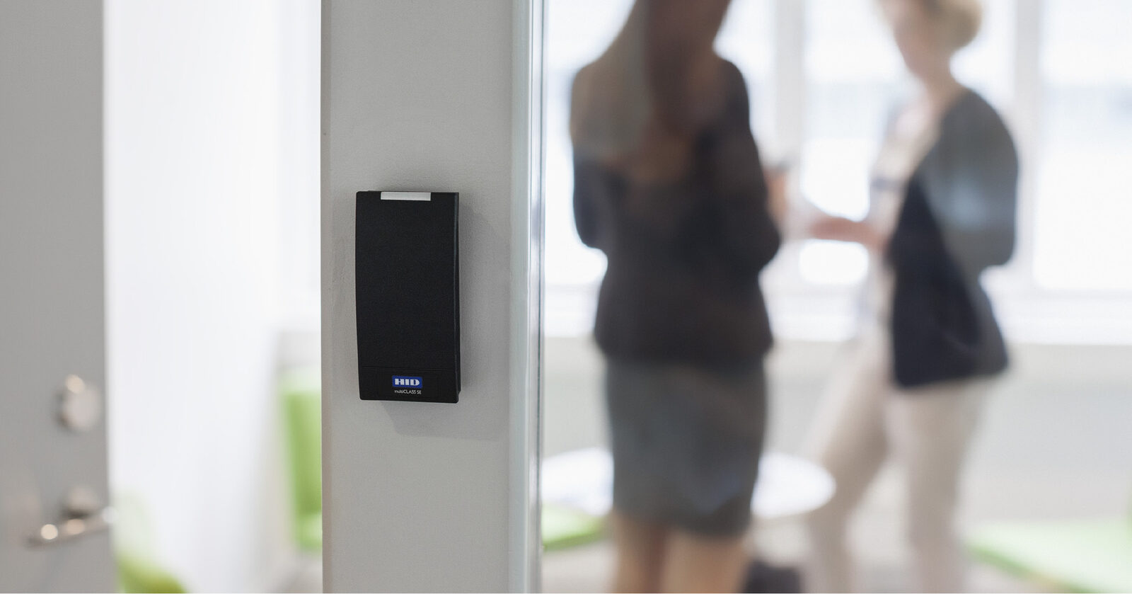 Employee using a secure access-control card reader at a commercial facility protected by Security ONE