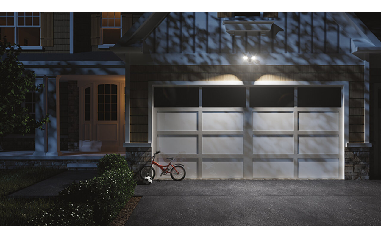 Home exterior lit up at night with smart automated lighting