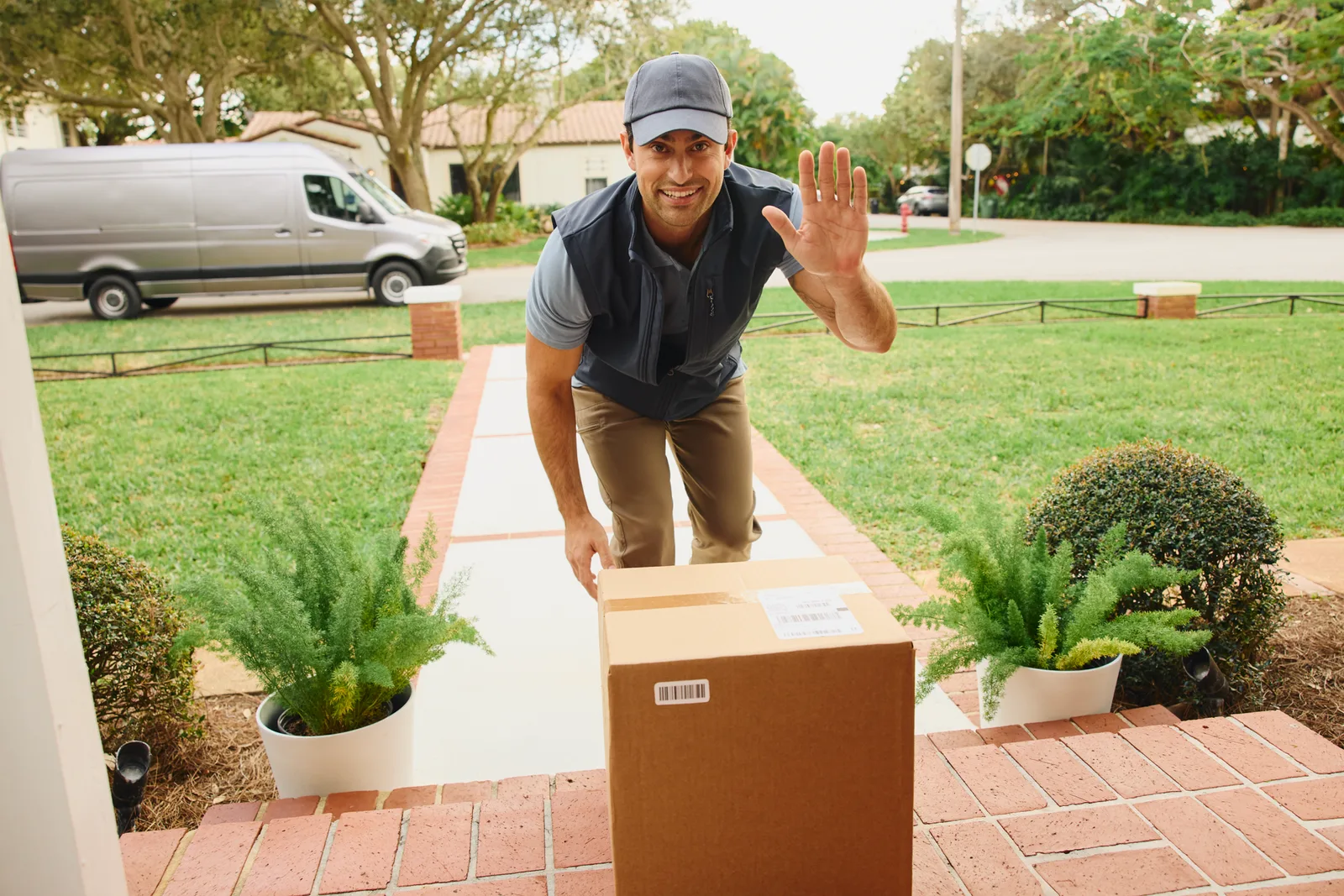 A package delivered safely on a home's front doorstep, viewed from the homeowner's perspective